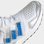 Close-up zoom on the front of the Adidas Ultraboost DNA x Lego Men's trainers, showing the Primeknit texture and unique lacing system.