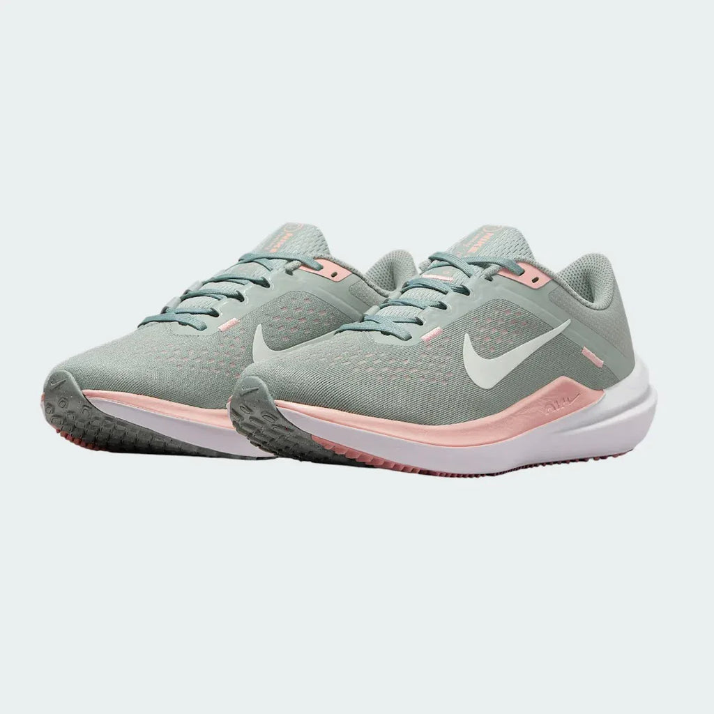 Angled view of two Nike Air Winflo 10 Women's green running shoes, side by side, showcasing their versatile design and cushioned profile.