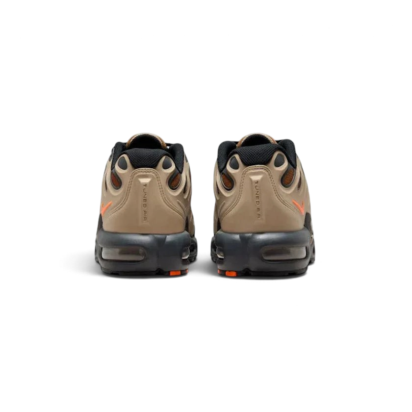 Focuses on the rear profile, highlighting the raised synthetic heel counter, debossed "Tn" badge, and the wide footprint of the foam midsole base enclosing the heel Air chambers.