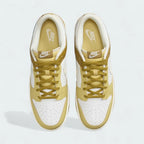 Top-down view of a pair of Nike Dunk Low Retro Men's sneakers in bronzine and coconut milk, highlighting their iconic silhouette and lace-up closure.