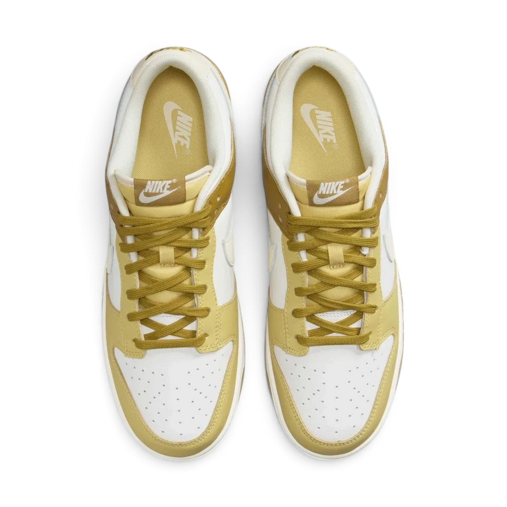 Top-down view of a pair of Nike Dunk Low Retro Men's sneakers in bronzine and coconut milk, highlighting their iconic silhouette and lace-up closure.
