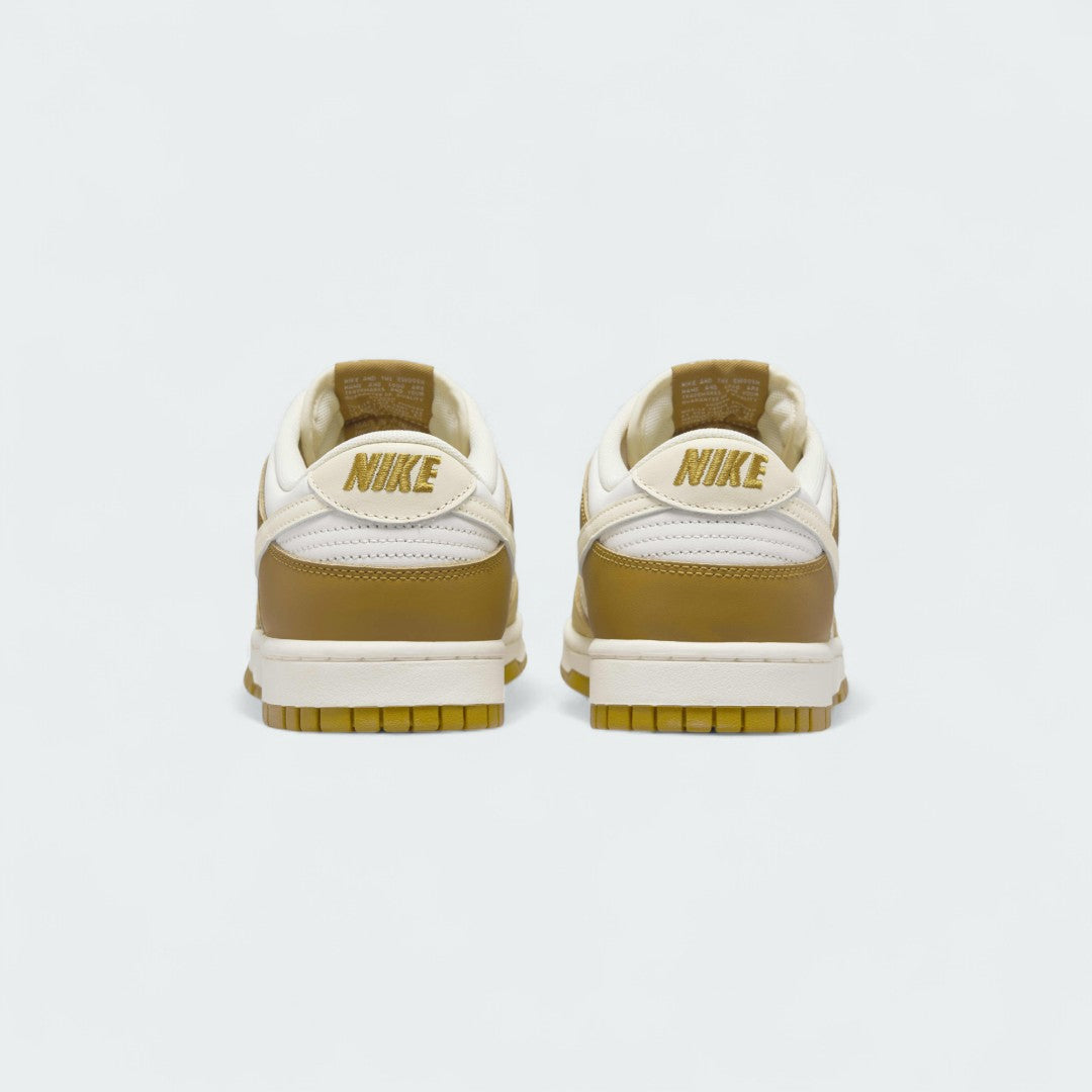 Rear view of the Nike Dunk Low Retro Men's bronze sneakers, focusing on the contrasting heel tab and Nike branding.