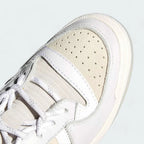 Close-up zoom on the front of the Adidas x Ivy Park Forum Low women's trainers, showing the perforated toe box, lace-up system, and X-detail.