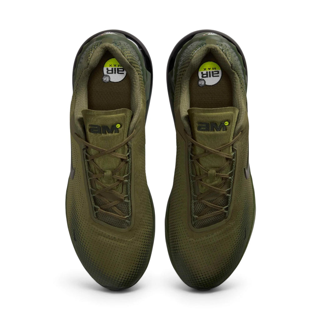 Overhead top-down view looking down at the laced trainers, displaying the olive flat laces, branded "AM" tongue tags, and printed insoles with Air Max graphics.
