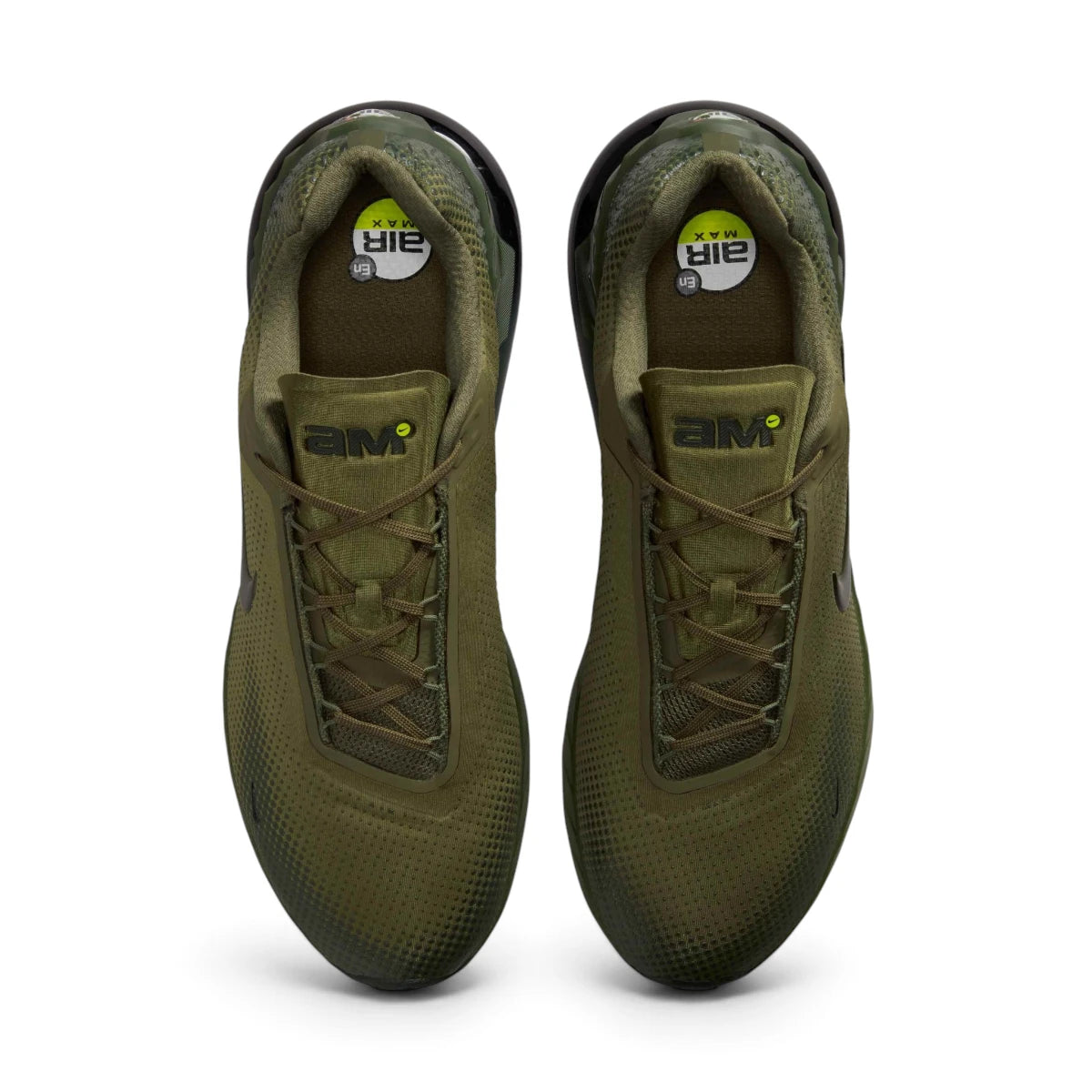 Overhead top-down view looking down at the laced trainers, displaying the olive flat laces, branded "AM" tongue tags, and printed insoles with Air Max graphics.