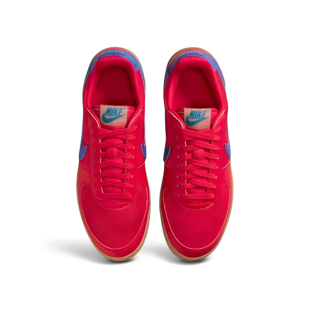 Looking down at the red lacing system, the woven textile panels, and the archival Nike branding on the tongue.