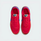 Looking down at the red lacing system, the woven textile panels, and the archival Nike branding on the tongue.