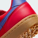 Highlighting the transition between the cushioned white foam midsole and the classic rubber waffle lugs.
