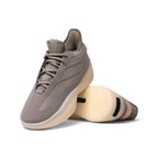 Dynamic angled layout displaying the textured outsole traction pattern alongside the sleek upper profile.