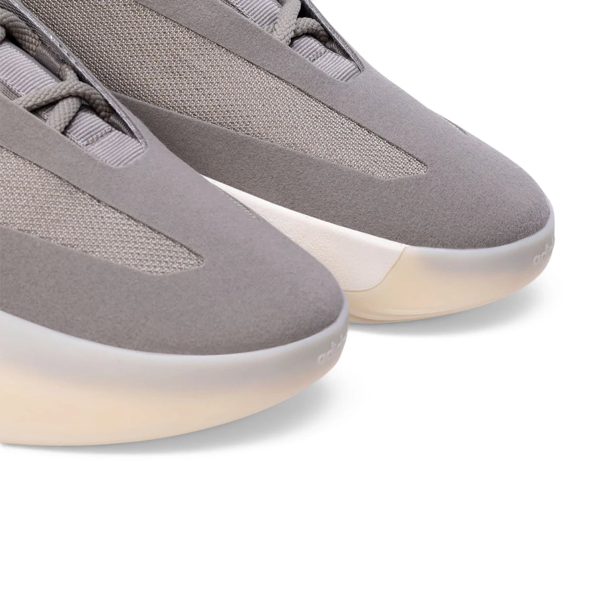 Macro focus on the fine-grained synthetic material texture, breathable monofilament side stripes, and the embossed adidas logo on the toe.