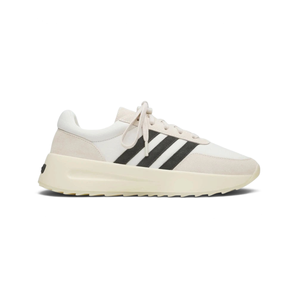 Side Profile Image: The Cream White L.A. Trainer, highlighting the iconic wavy midsole and the subtle tonal Three Stripes.