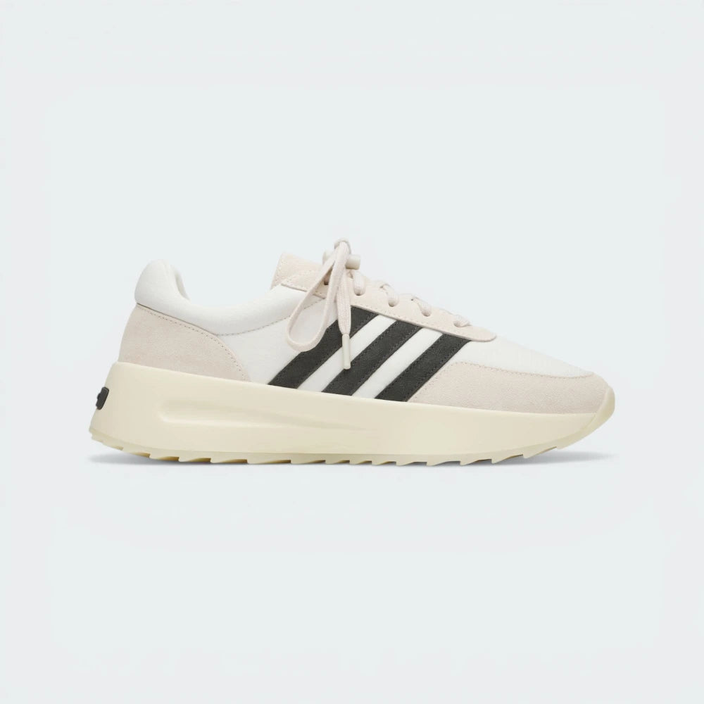 Side Profile Image: The Cream White L.A. Trainer, highlighting the iconic wavy midsole and the subtle tonal Three Stripes.