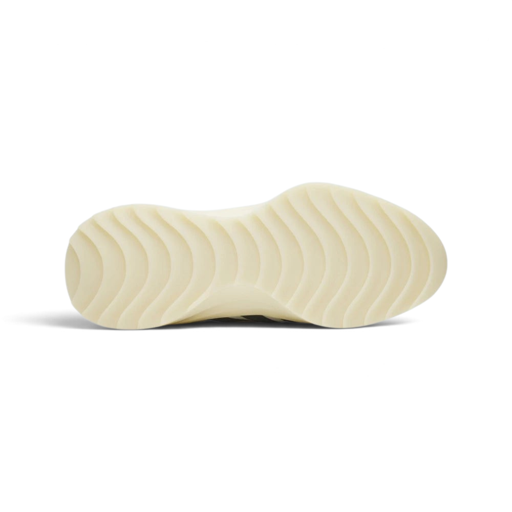 Outsole View: Showing the unique wavy traction pattern on the cream rubber sole.