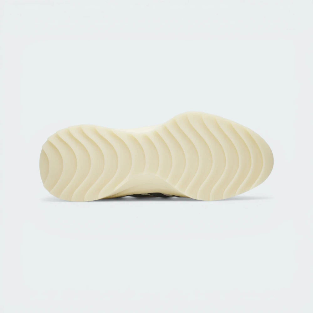 Outsole View: Showing the unique wavy traction pattern on the cream rubber sole.
