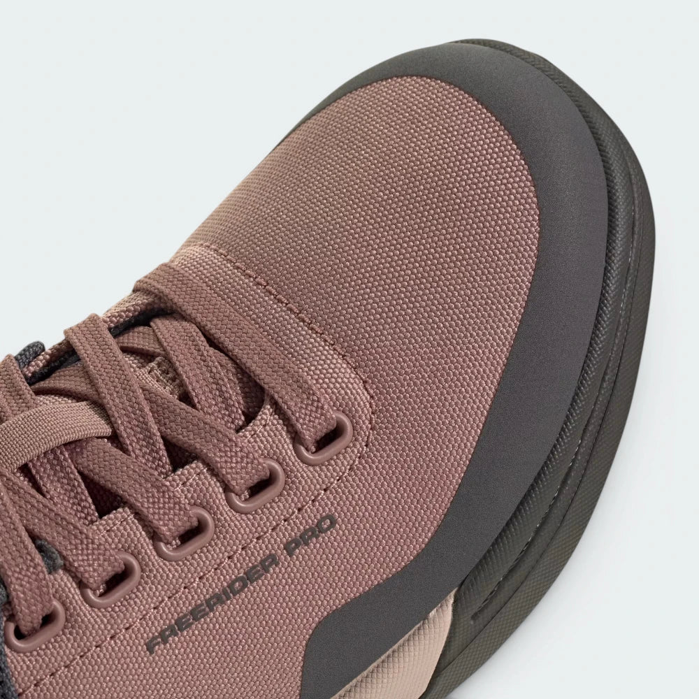 Details the premium stitching framing the reinforced toe cap zone and the precision eyelets configured to pull the fit completely tight.