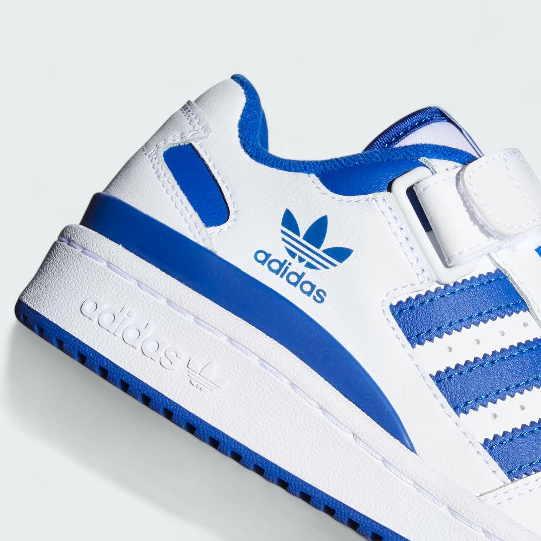 Close-up zoom on the front of the Adidas Forum Low Juniors' white trainers, showing the perforated toe box, lace-up system, and X-detail.