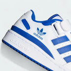 Close-up zoom on the front of the Adidas Forum Low Juniors' white trainers, showing the perforated toe box, lace-up system, and X-detail.