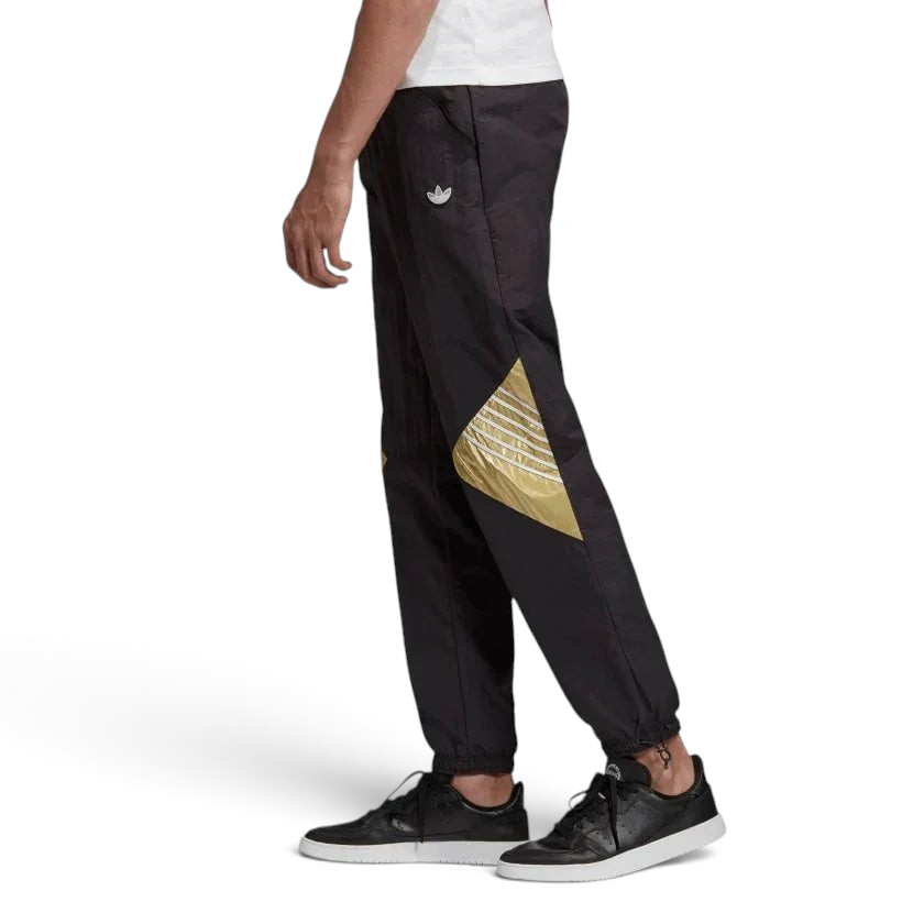 Adidas Tolima 02 Men's Track Pants in black nylon, front view showing elastic waistband, drawcord, side pockets, and classic Adidas 3-Stripes down the legs. Main image