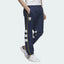 Adidas Arsenal 91-93 Track Pants Men's in collegiate navy, front view showing elastic waistband, red 3-Stripes down the legs, and embroidered Arsenal FC crest.