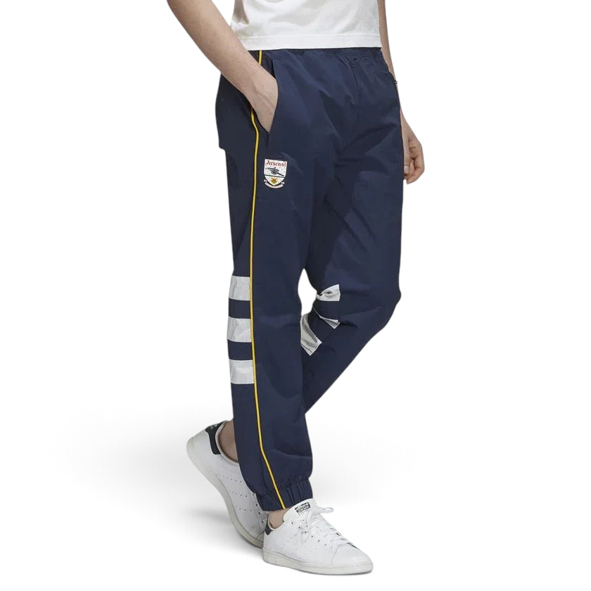 Adidas Arsenal 91-93 Track Pants Men's in collegiate navy, front view showing elastic waistband, red 3-Stripes down the legs, and embroidered Arsenal FC crest. Main image