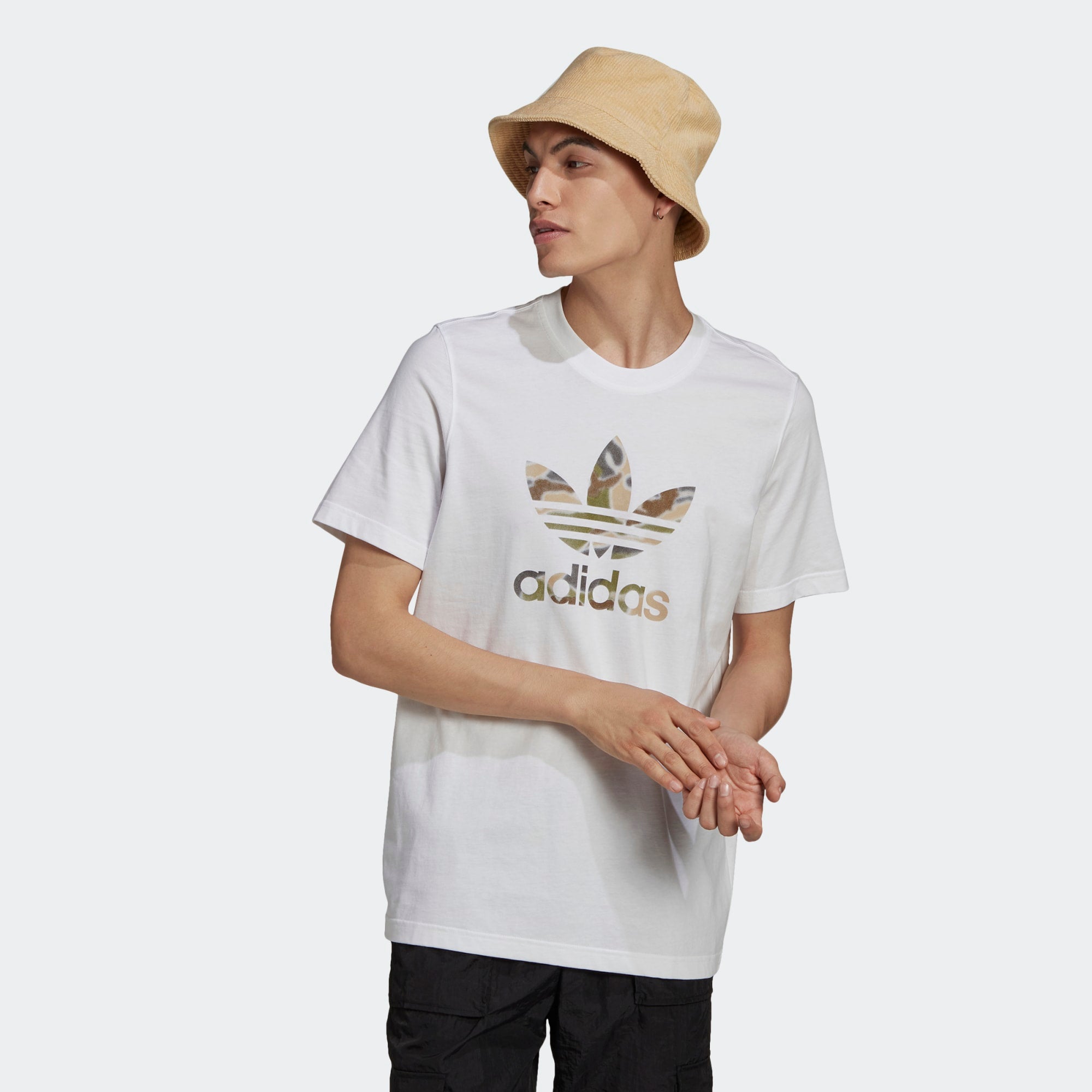 Highlights the high-velocity sweep of the central graphic print, showing the professional, clean texture of the white fine knit cotton body and the sharp contrast of the multi-colour spray-paint styling across the chest. Main image