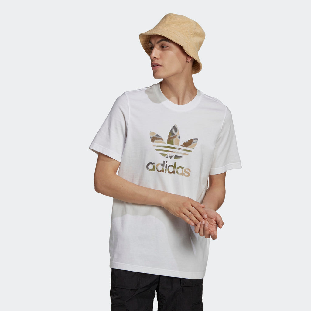 Highlights the high-velocity sweep of the central graphic print, showing the professional, clean texture of the white fine knit cotton body and the sharp contrast of the multi-colour spray-paint styling across the chest.