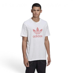 A man wearing a white Adidas t-shirt with a pink Trefoil logo on the front.