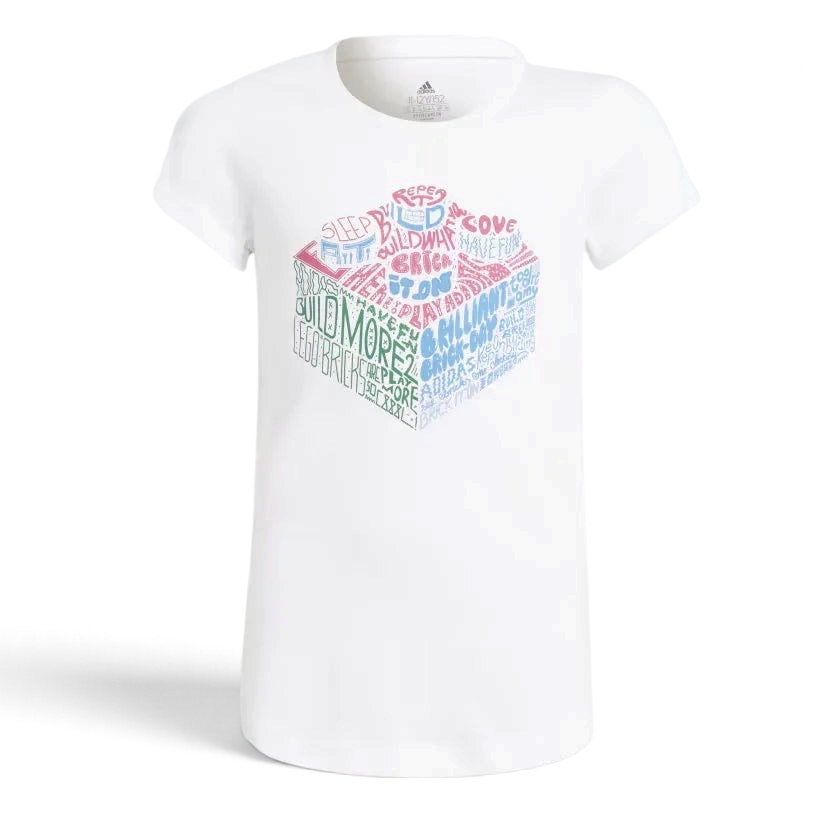 White Adidas x Lego girls graphic t-shirt with colorful Lego pieces and text design on the front. Main image