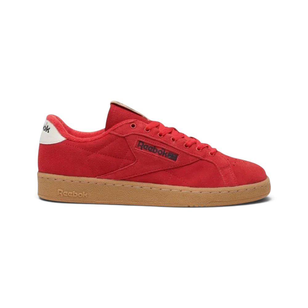 Side profile of the Reebok Club C Grounds UK in Vector Red suede, showing the Glen Green side stripes and the vintage gum rubber outsole. Main image