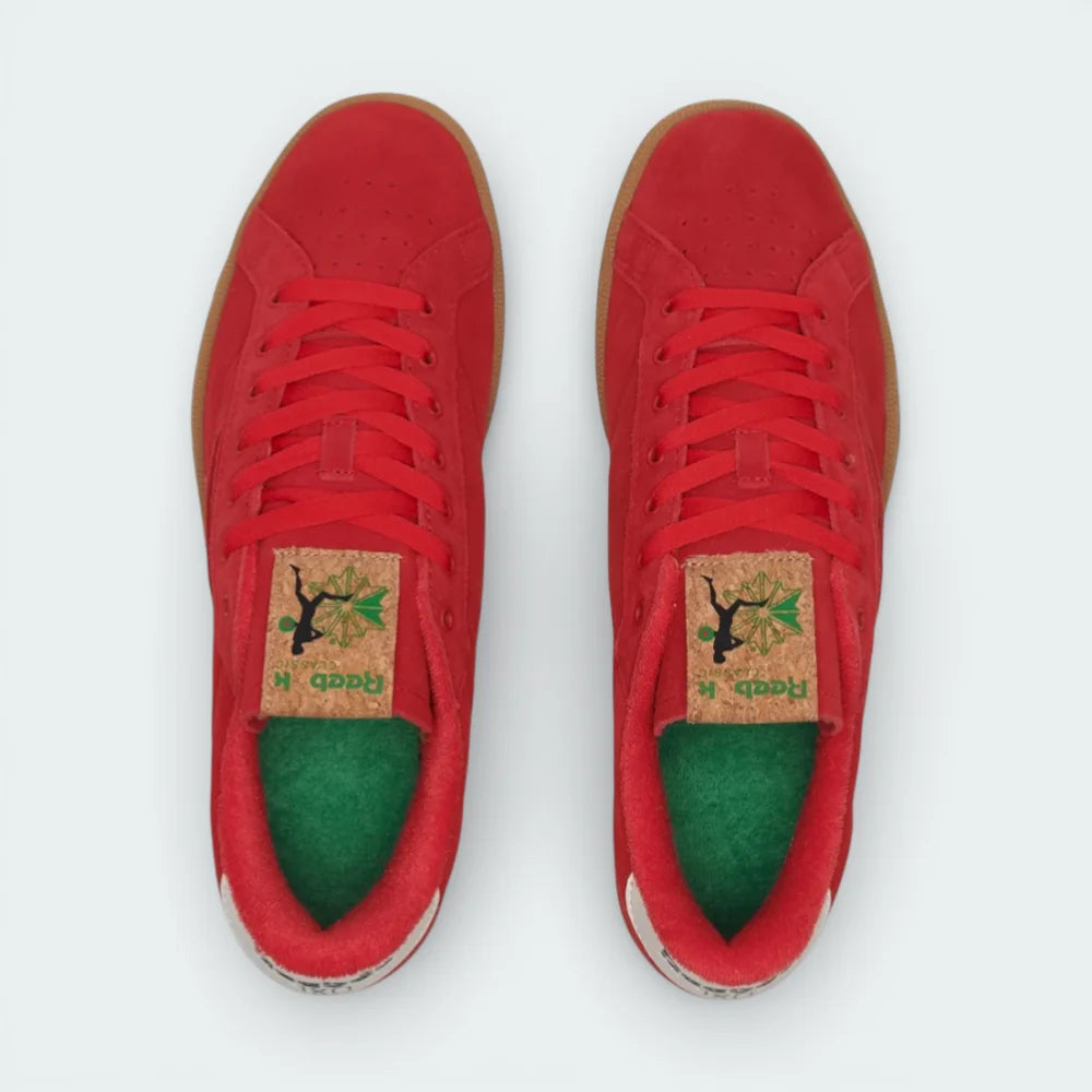 Top-down view of the red and green Reebok trainers, highlighting the soft suede texture and the matching red lacing system.