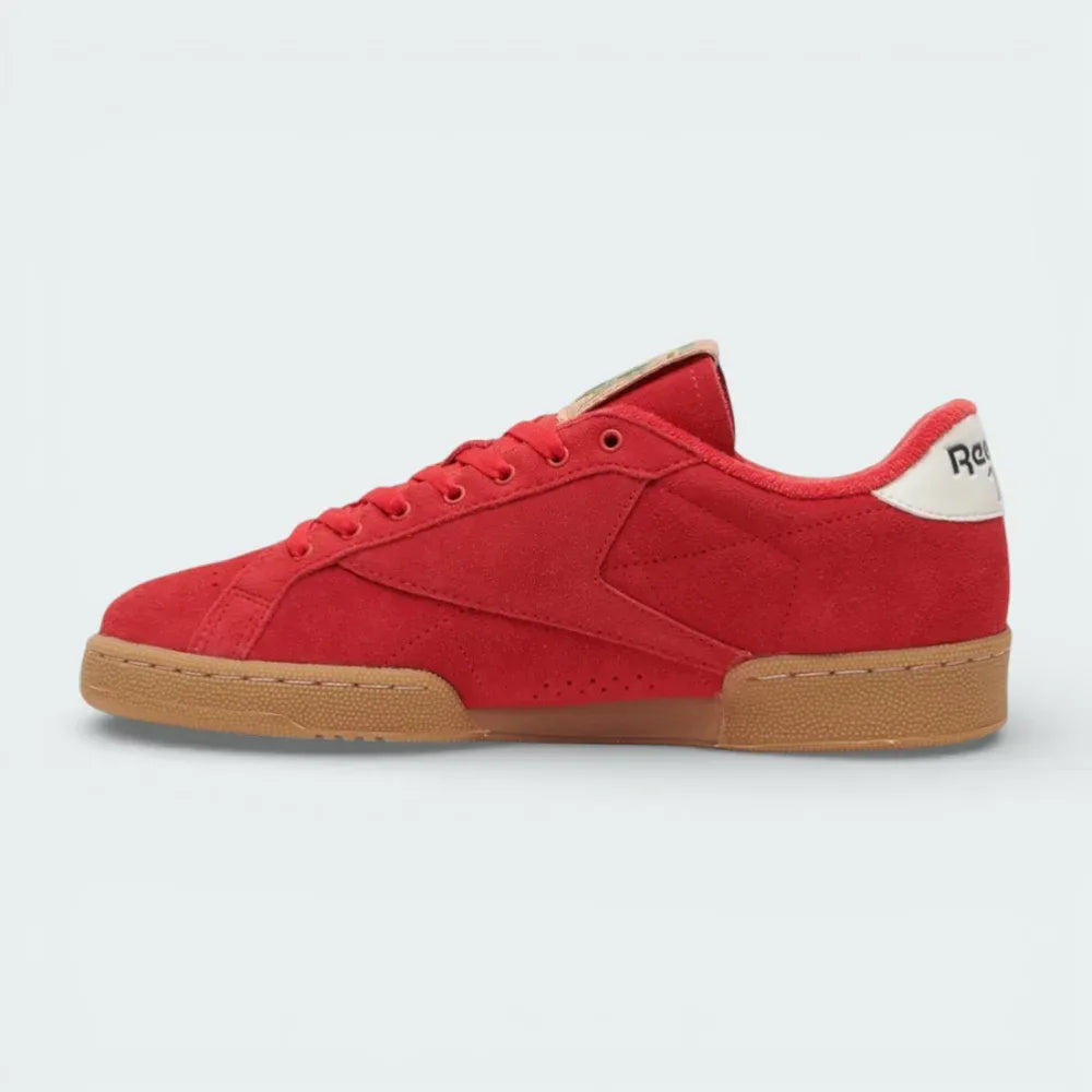 Side shot of the Reebok Club C Grounds trainers showcasing the vibrant colour contrast and the classic low-top silhouette.