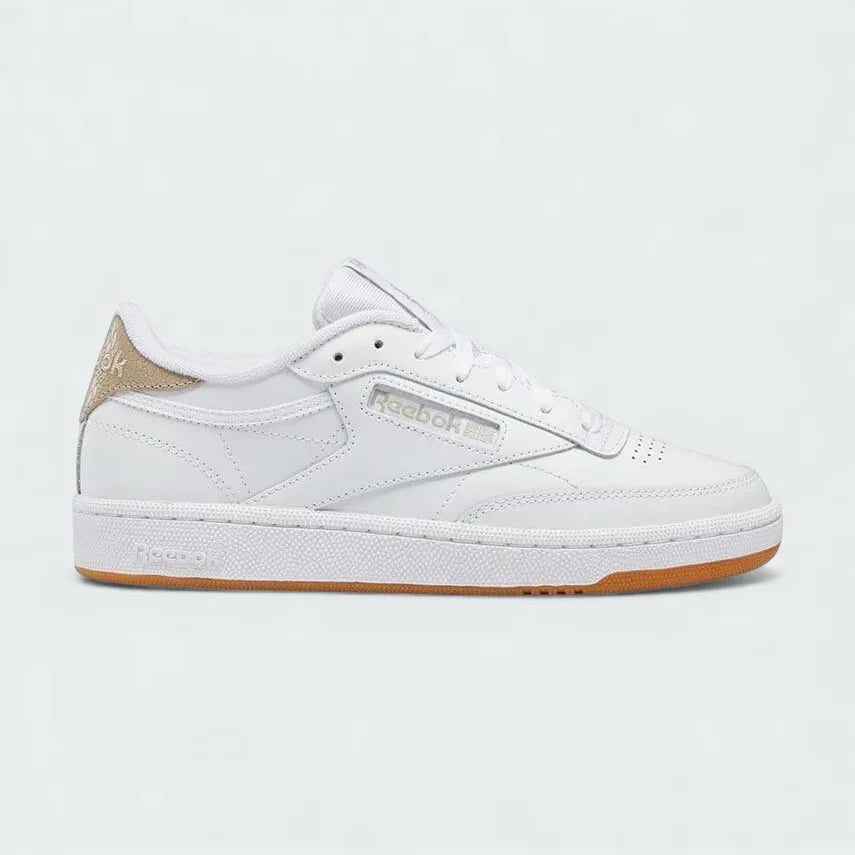 Reebok Classic Club C 85 women's trainers in white leather, side profile showing the iconic low-cut silhouette, cushioned midsole, and Reebok window logo.