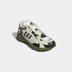 Angled view of Adidas x Ivy Park Savage V4 sneakers in core white with green and blue accents, side by side, showcasing their bold design.