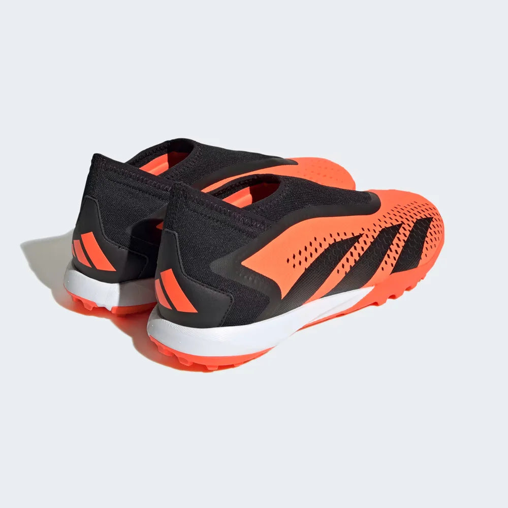 Angled view of two Adidas Predator Accuracy.3 Laceless Turf Boots in orange and black, side by side, showcasing their bold design from behind