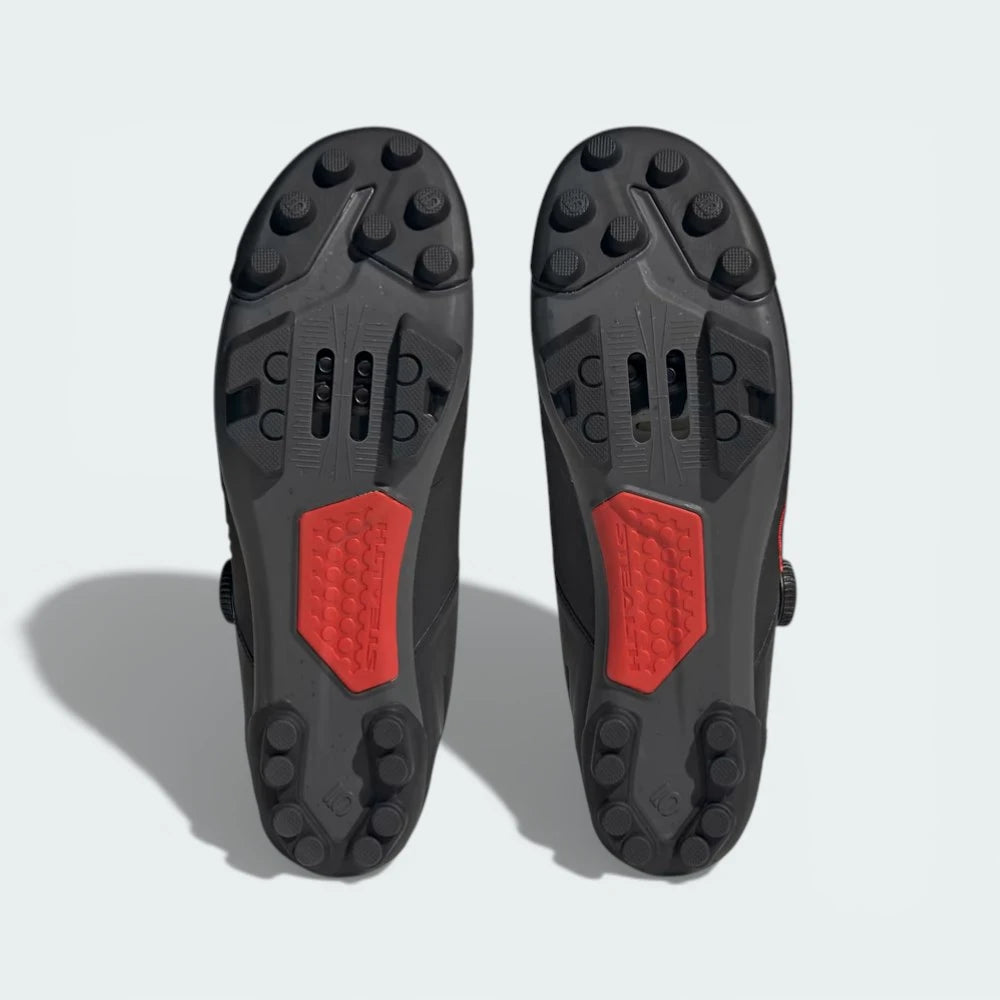 View of the Stealth Marathon rubber outsole, showcasing the cleat mounting area and the high-friction lug pattern.
