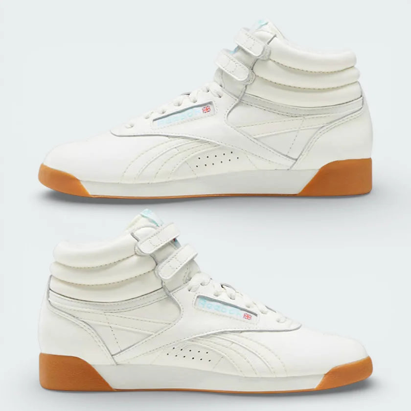 Side profile of the Reebok Freestyle Hi 40th Anniversary in Chalk ivory leather, showing the dual ankle straps and Digital Blue branding.
