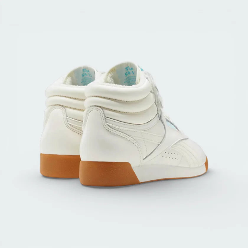 Angled shot of both Reebok Freestyle Hi trainers side by side, showcasing the heel and underside of the tongue