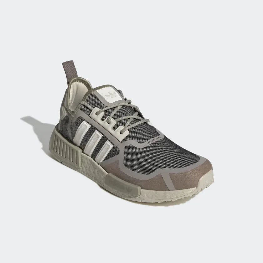 Angled view of Adidas NMD_R1 women's shoes in bliss pink, cream white, and light brown, side by side, showcasing their sleek, futuristic design.