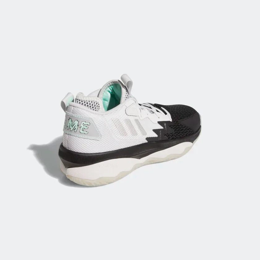 Focuses on the structured heel support and the professional finish of the Dame signature branding.