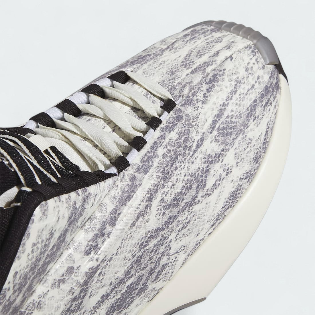 Close-up zoom on the front toe box of the Adidas Crazy 1 Men's "Snake Skin" trainers, detailing the moulded texture and white finish.