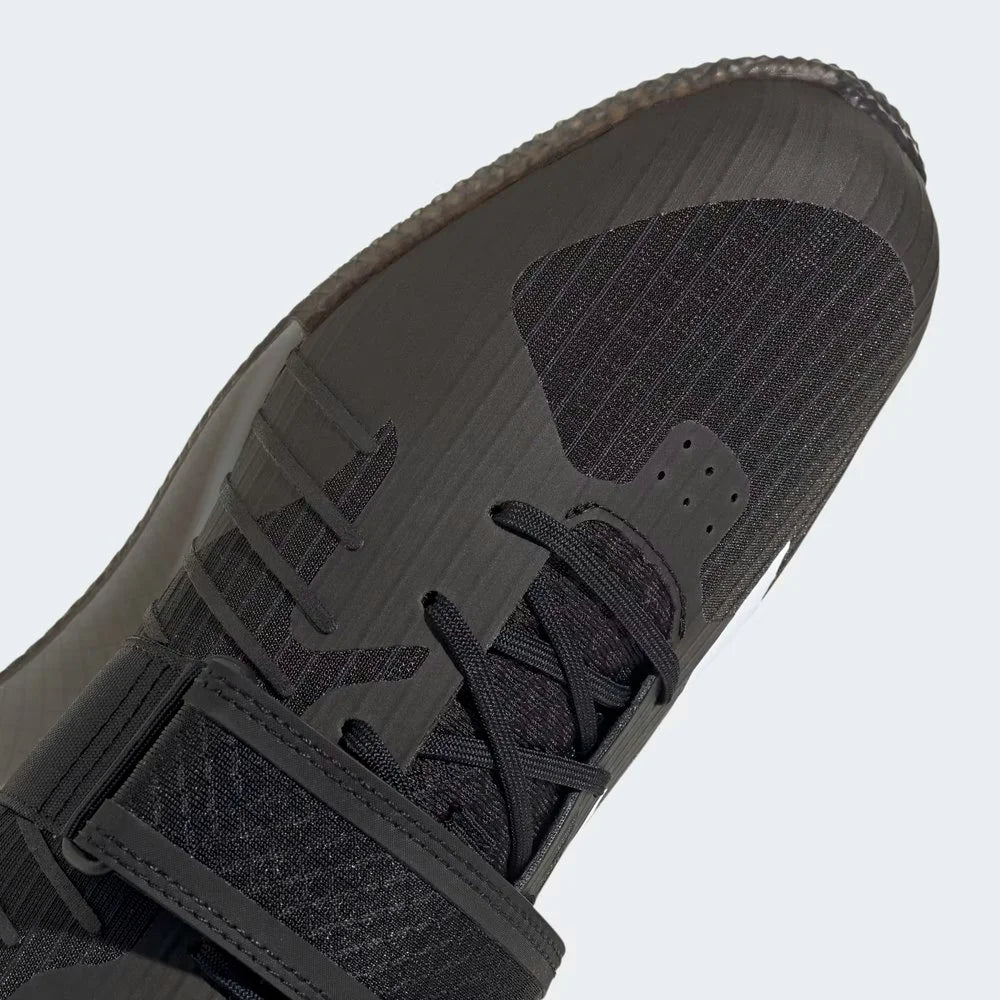Close-up zoom on the front of the Adidas Adipower Weightlifting III Men's shoes, detailing the lace-up system and the crucial hook-and-loop midfoot strap.