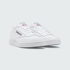 Angled view of two Reebok Classic Club C 85 Unisex white trainers, side by side, showcasing their timeless aesthetic and classic court design.