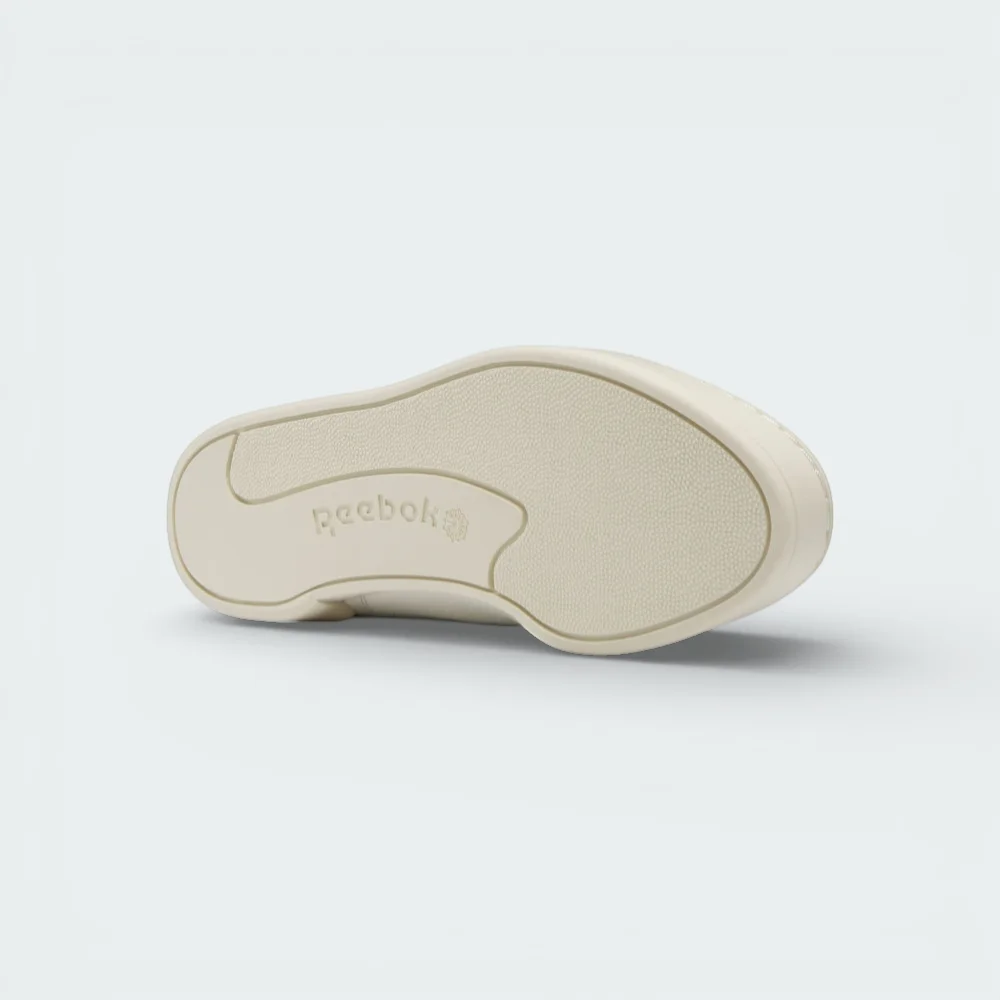 View of the durable rubber outsole, showcasing the classic Club C traction pattern in a tonal Alabaster finish.