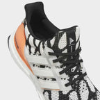 Close-up zoom on the upper of the Adidas Ultraboost 1.0 x Marimekko running shoes, showing the texture of the Primeknit yarn and the vibrant print.