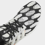 Close-up zoom on the upper of the Adidas Ultraboost 1.0 x Marimekko running shoes, showing the texture of the Primeknit yarn and the vibrant print.