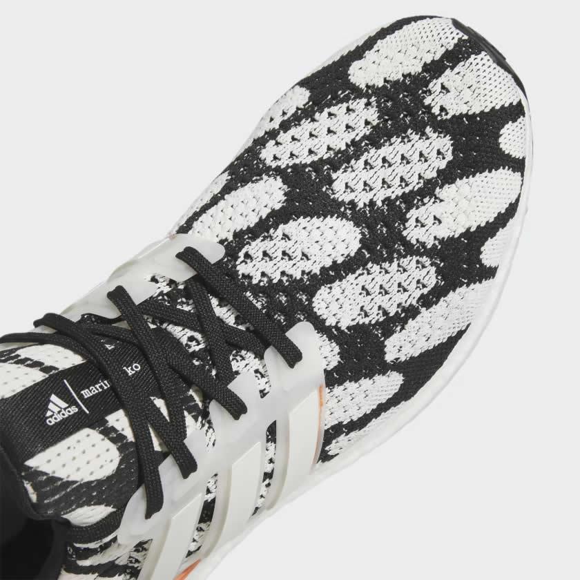 Close-up zoom on the upper of the Adidas Ultraboost 1.0 x Marimekko running shoes, showing the texture of the Primeknit yarn and the vibrant print.