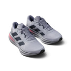Overhead view looking down at the laced silver running shoes, displaying the tonal flat laces, breathable tongue label, and comfortable branded insole.
