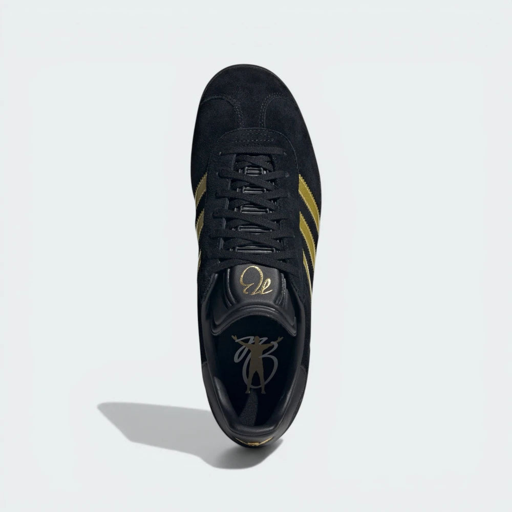 Looking down at the black leather lacing system and the gold Bellingham branding on the moulded tongue.