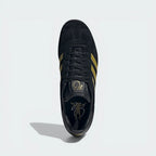 Looking down at the black leather lacing system and the gold Bellingham branding on the moulded tongue.