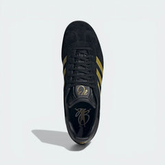 Looking down at the black leather lacing system and the gold Bellingham branding on the moulded tongue.